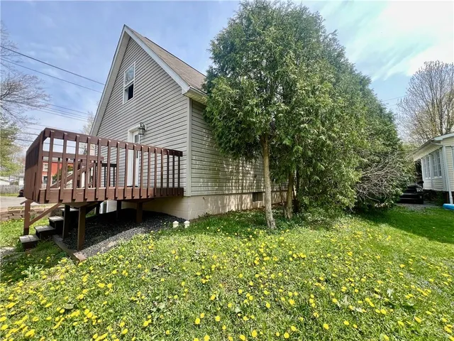 a view of a house with a yard and flower plants