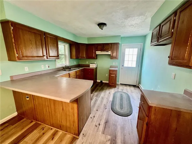 a kitchen with wooden cabinets a sink and a stove