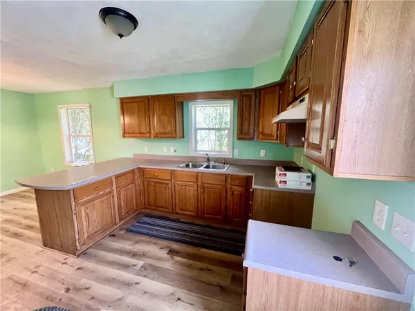 a kitchen with kitchen island granite countertop a sink stove and cabinets