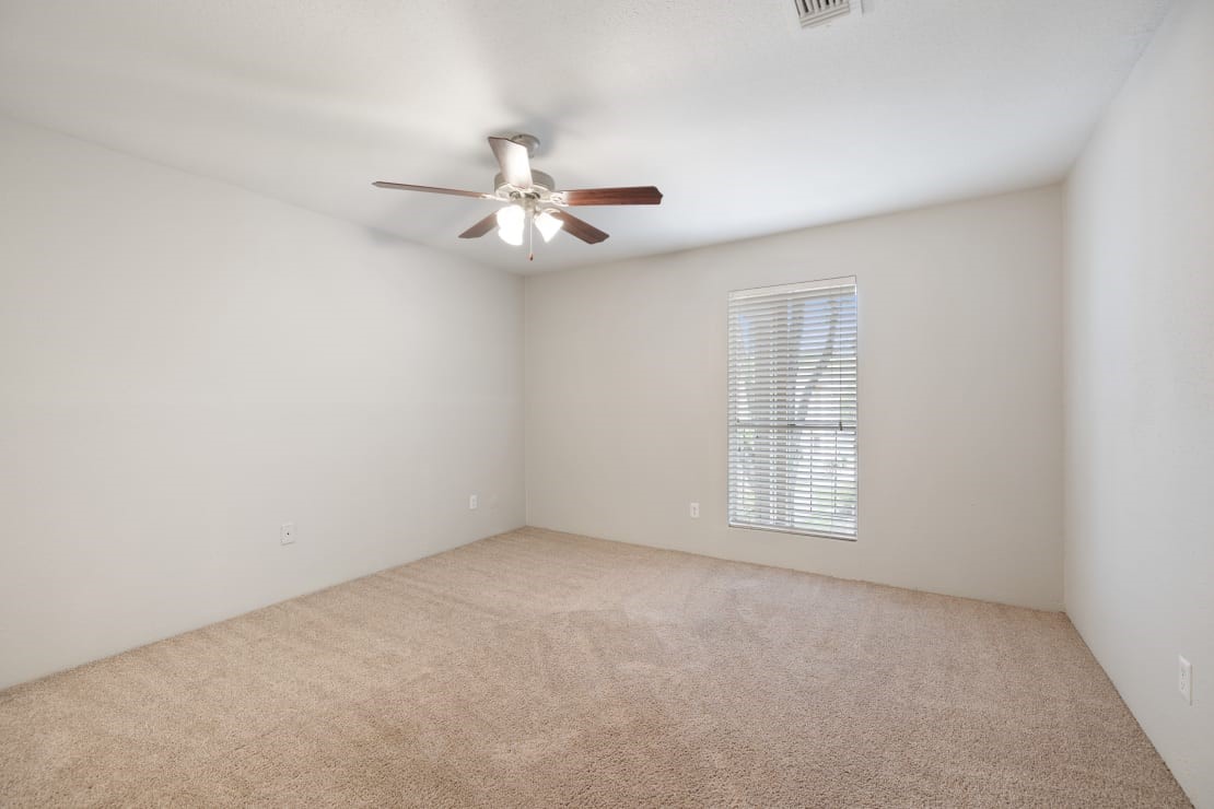 2800 South Ashford Road, Unit 2224 Houston, TX 77082 - Photo 18 of 35 an empty room with chandelier fan and windows