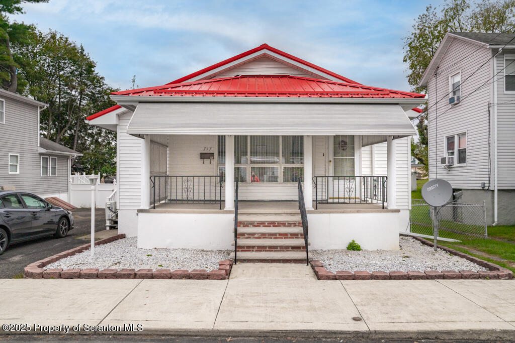 717 Beech Street Old Forge, PA 18518 - Photo 1 of 27 a front view of a house with a yard and potted plants