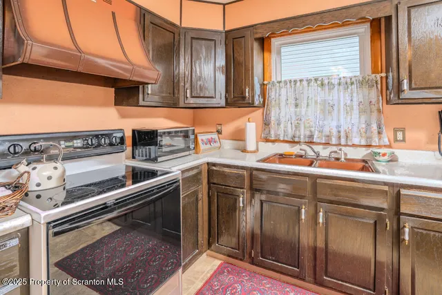 a kitchen with a sink cabinets and stainless steel appliances