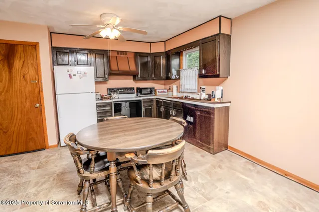 a kitchen with stainless steel appliances kitchen island granite countertop a sink and cabinets