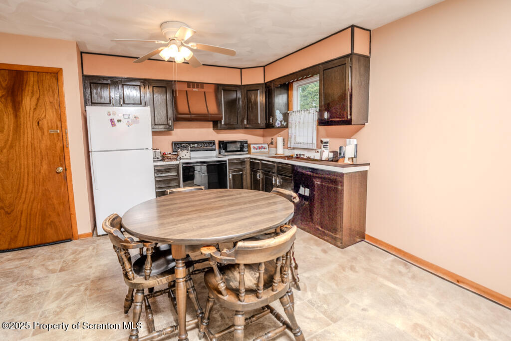 717 Beech Street Old Forge, PA 18518 - Photo 12 of 27 a kitchen with stainless steel appliances kitchen island granite countertop a sink and cabinets