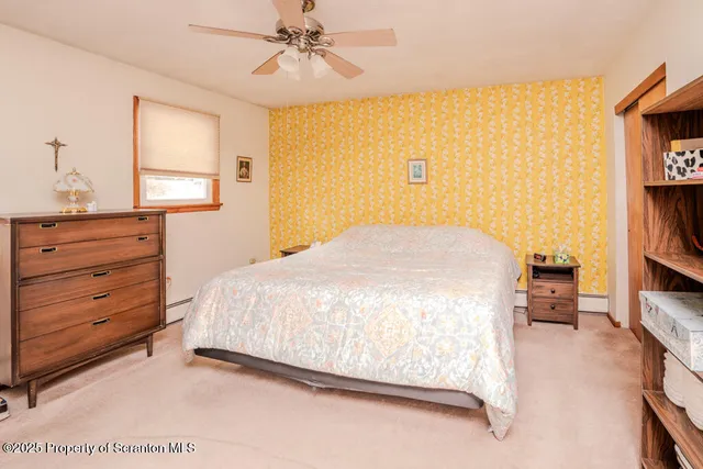 a bedroom with a bed and a book shelf