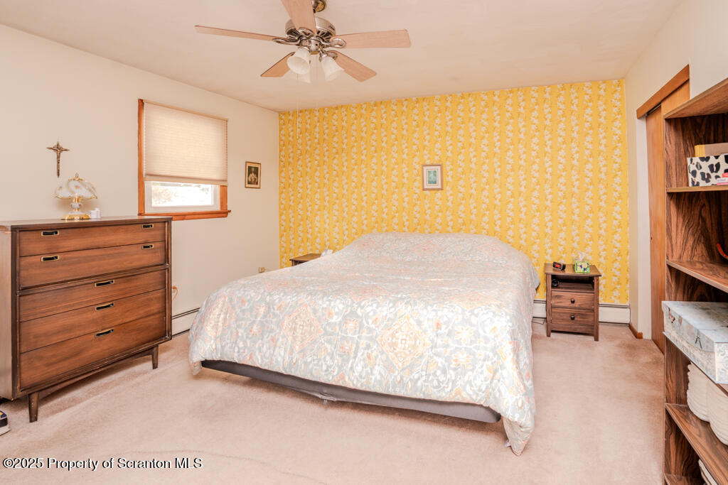 717 Beech Street Old Forge, PA 18518 - Photo 13 of 27 a bedroom with a bed and a book shelf