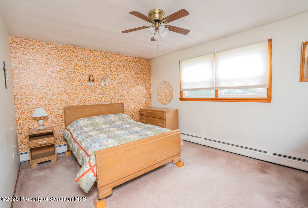 717 Beech Street Old Forge, PA 18518 - Photo 14 of 27 a bedroom with a bed and window