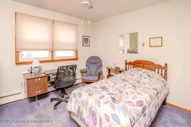 a bedroom with two beds and a large window