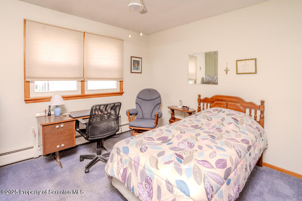 717 Beech Street Old Forge, PA 18518 - Photo 15 of 27 a bedroom with two beds and a large window