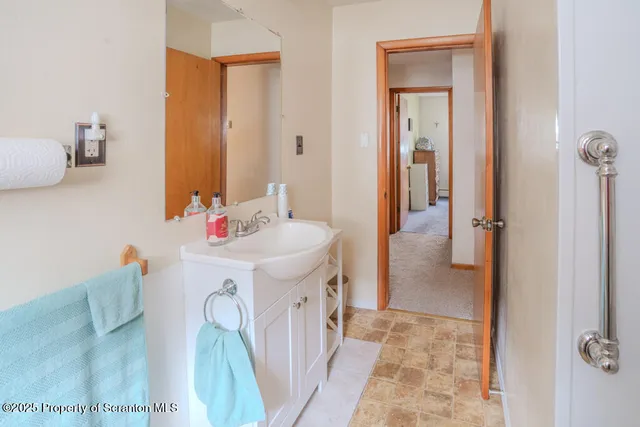 a bathroom with a sink a mirror and vanity