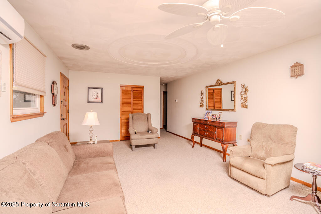 717 Beech Street Old Forge, PA 18518 - Photo 7 of 27 a living room with furniture a dining table and a piano table