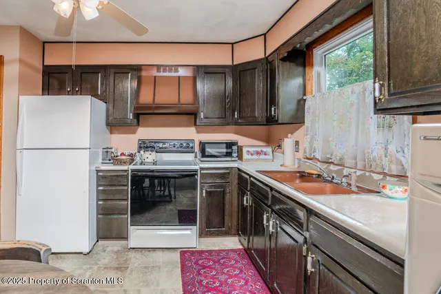 a kitchen with a sink stove and refrigerator