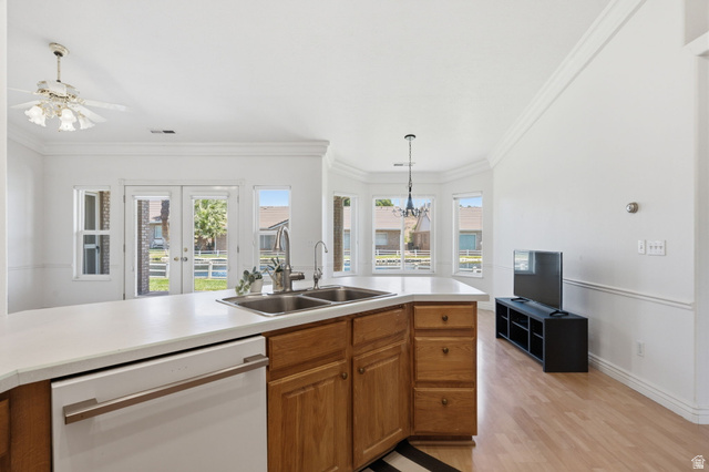 805 South River Road, Unit 70 St. George, UT 84790 - Photo 9 of 38 Open-concept living space featuring a kitchen island with dual sinks, wood cabinetry, and a light-colored countertop