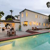 a view of a house with swimming pool and sitting area
