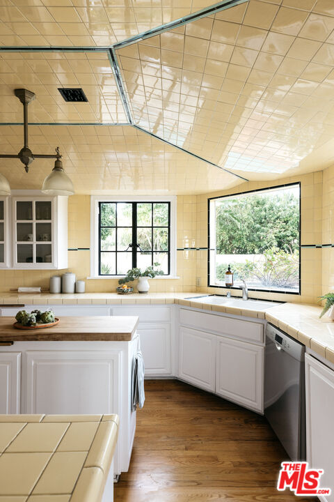 3681 Fairland Boulevard View Park, CA 90043 - Photo 28 of 54 a large kitchen with stainless steel appliances granite countertop a sink and wooden cabinets