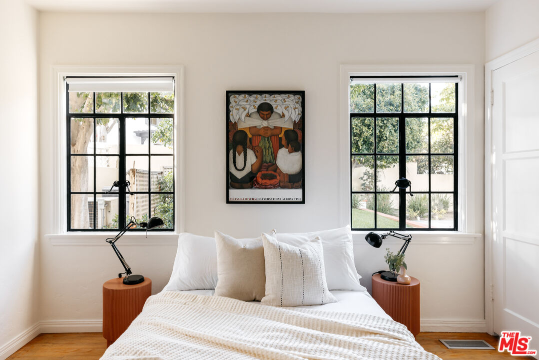 3681 Fairland Boulevard View Park, CA 90043 - Photo 30 of 54 a bedroom with a bed and wooden floor