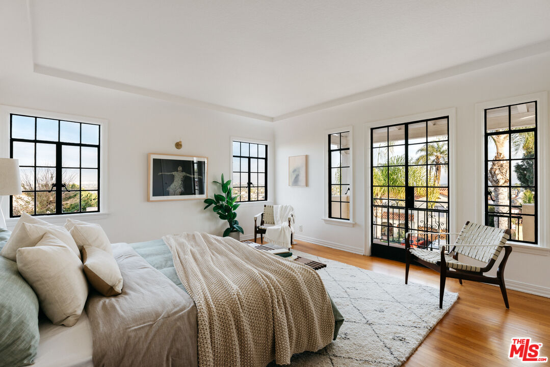 3681 Fairland Boulevard View Park, CA 90043 - Photo 37 of 54 a bedroom with a bed and large windows