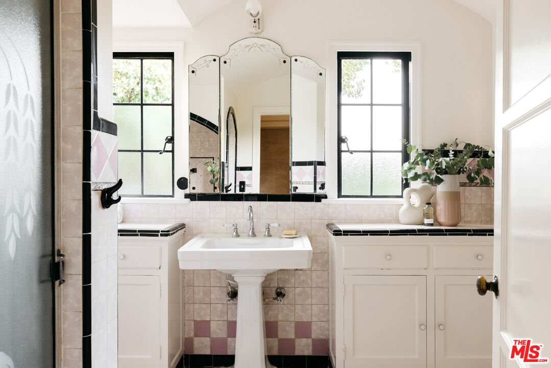 3681 Fairland Boulevard View Park, CA 90043 - Photo 41 of 54 a bathroom with a sink and a mirror