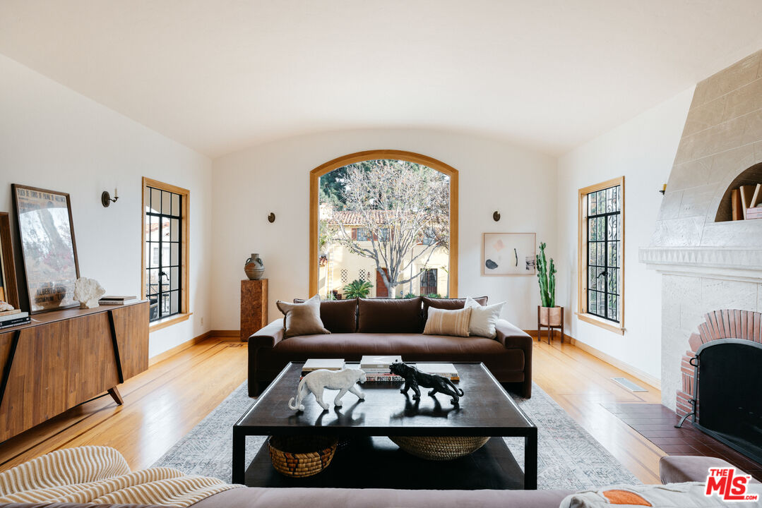 3681 Fairland Boulevard View Park, CA 90043 - Photo 8 of 54 a living room with furniture fireplace and a large window