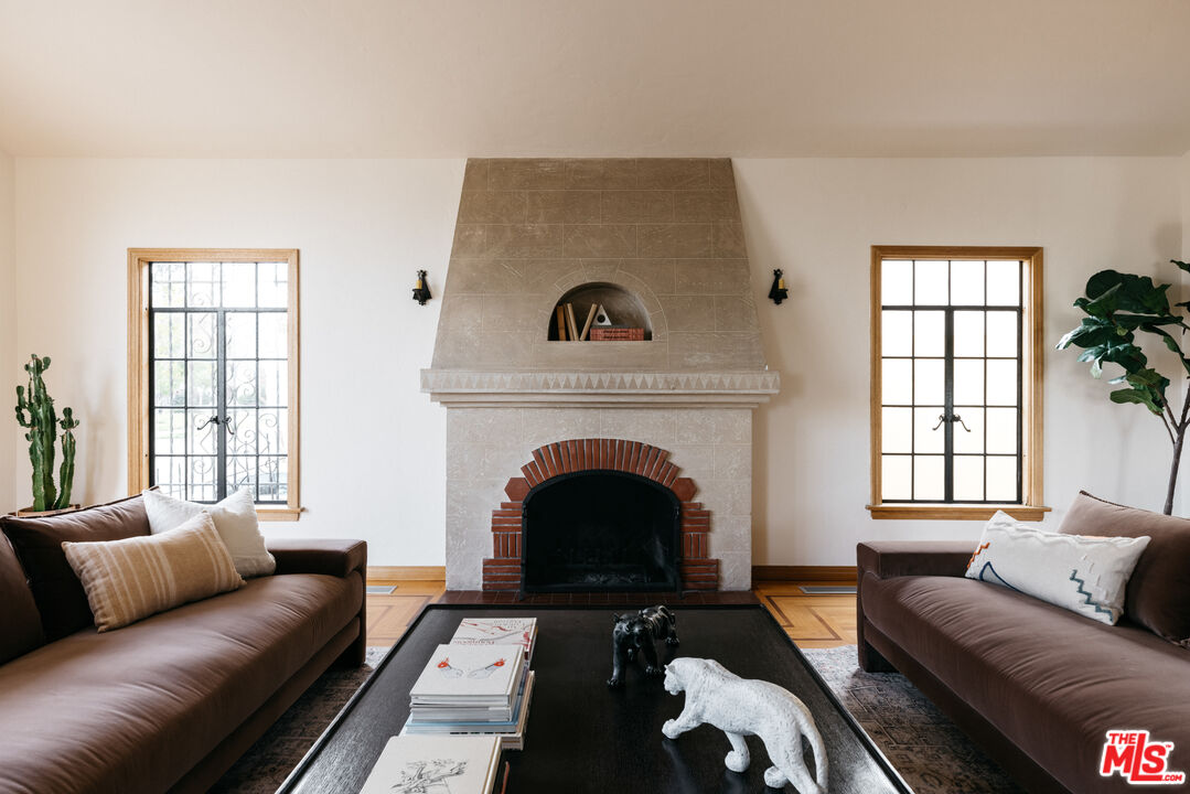 3681 Fairland Boulevard View Park, CA 90043 - Photo 9 of 54 a living room with furniture and a fireplace