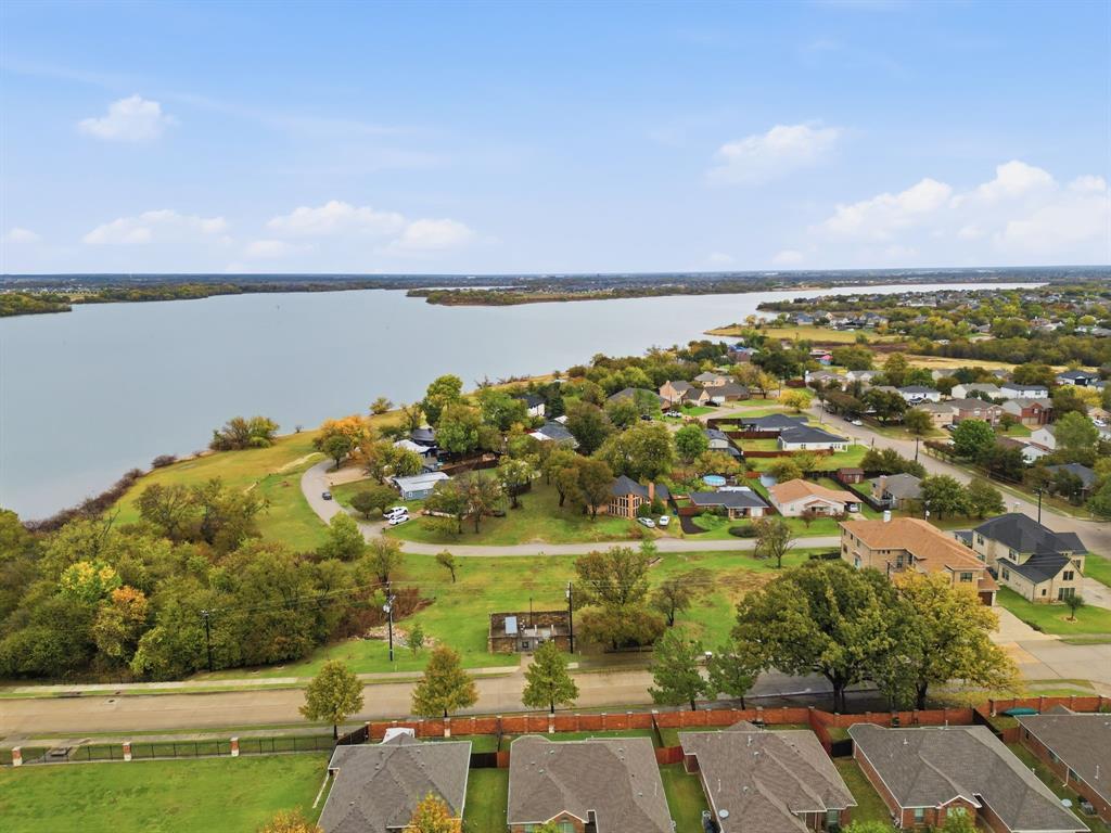 an aerial view of ocean with residential houses with outdoor space