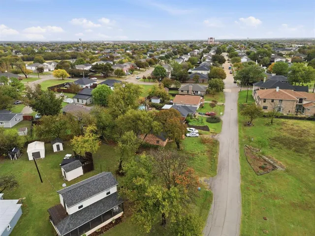 an aerial view of residential houses with outdoor space