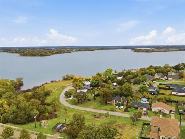 a view of a lake with houses in the back