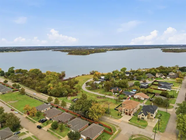 view of a lake with houses in the back