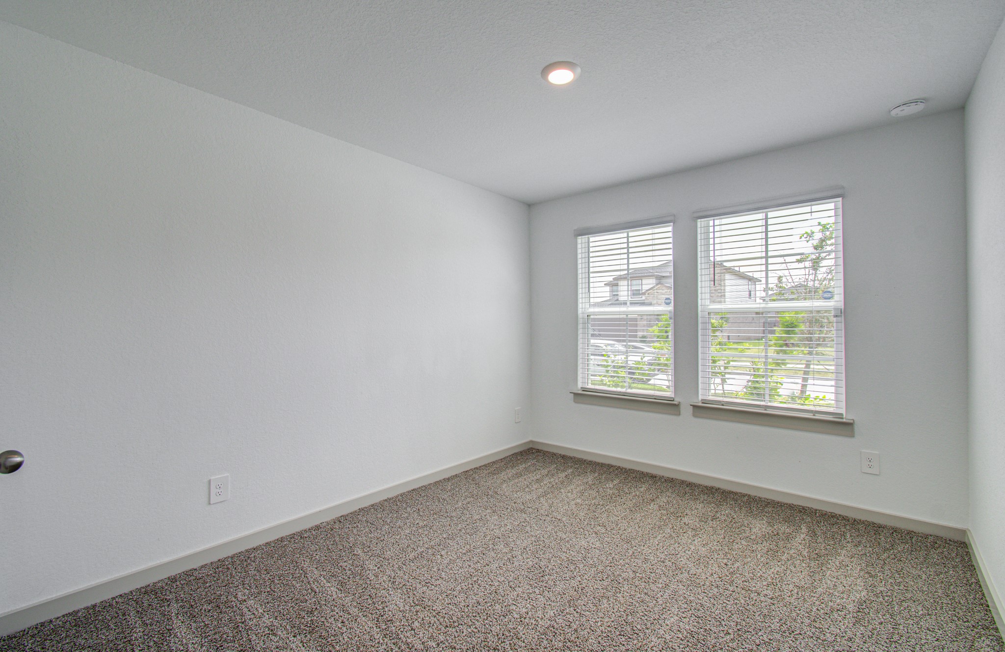 7903 Wrangler Shack Lane Rosharon, TX 77583 - Photo 6 of 29 This inviting, carpeted bedroom features neutral walls and two large windows that flood the space with natural light, creating a serene and comfortable haven.