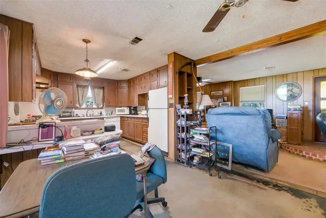 a living room with furniture and kitchen view
