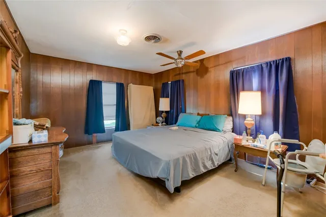 a bed room with a bed and a dresser