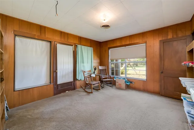 a view of a room with gym equipment and a large window