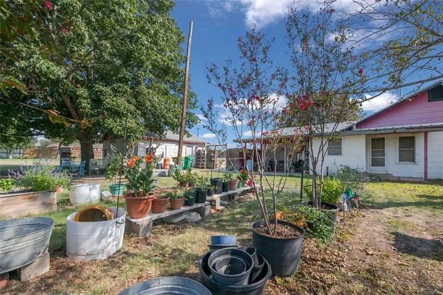 a view of a house with backyard and sitting area