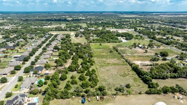 an aerial view of residential house with beach and trees around