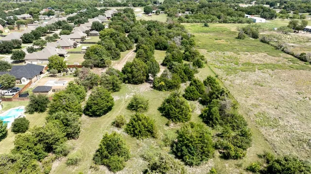 an aerial view of a houses with a yard