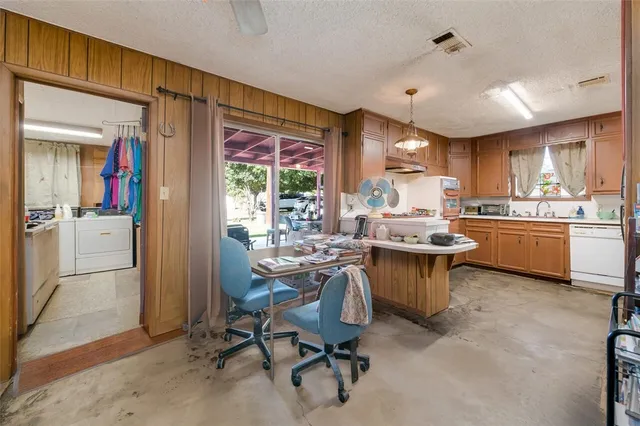 a kitchen with a sink appliances and cabinets