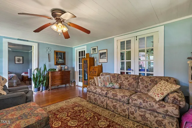 a living room with furniture ceiling fan and a window