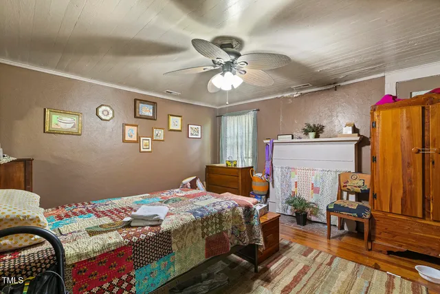 a bedroom that has a bed and a workspace