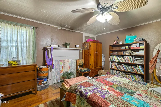 a bedroom that has a bed and a chandelier