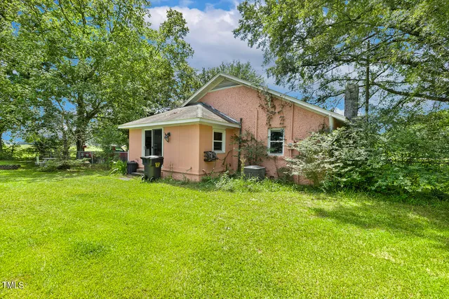 a front view of a house with yard and green space