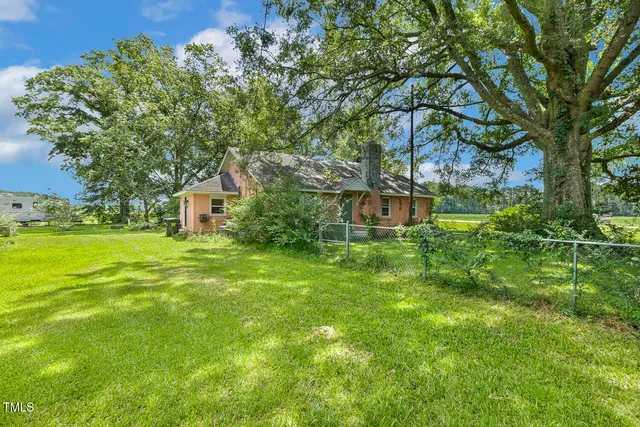 a view of yard with swimming pool and green space
