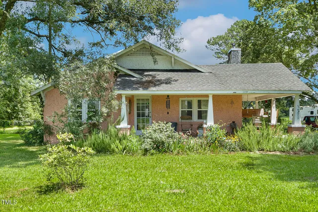 a front view of house with yard and green space