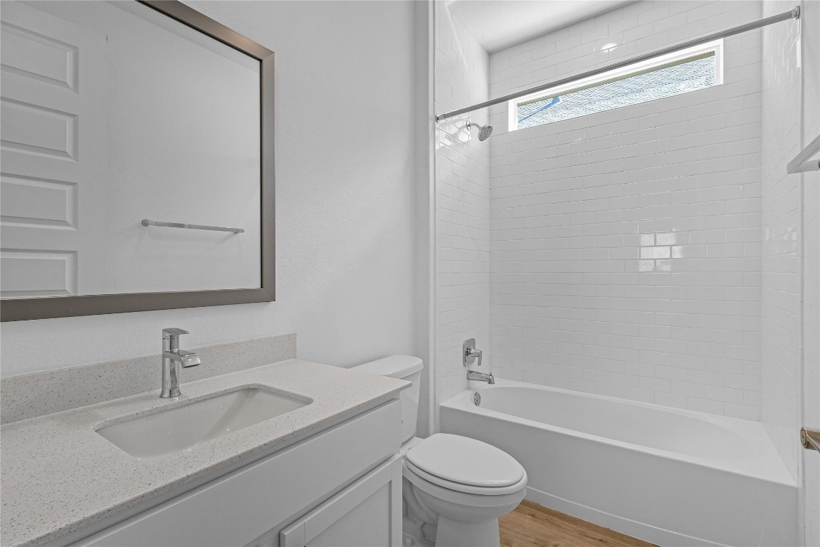 1925 Ruger Pass Leander, TX 78641 - Photo 11 of 26 a bathroom with a granite countertop sink toilet and shower