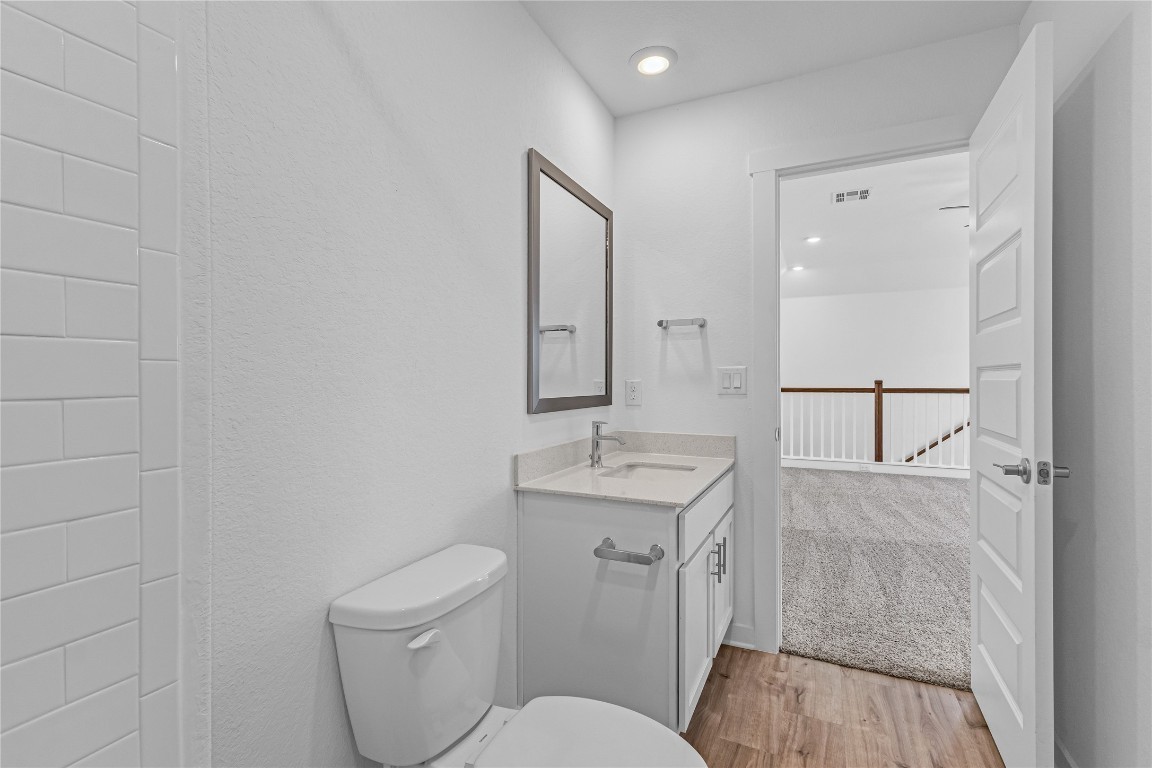 1925 Ruger Pass Leander, TX 78641 - Photo 20 of 26 a bathroom with a toilet a sink and mirror