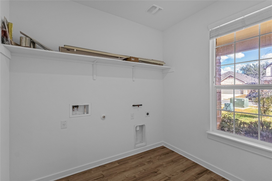 1925 Ruger Pass Leander, TX 78641 - Photo 22 of 26 a view of a room with wooden floor and windows
