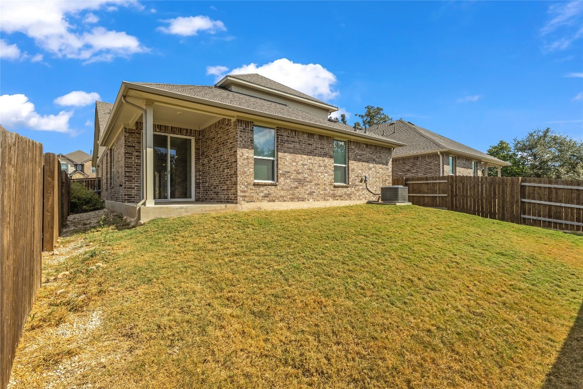 1925 Ruger Pass Leander, TX 78641 - Photo 23 of 26 a view of a house with a large window and yard