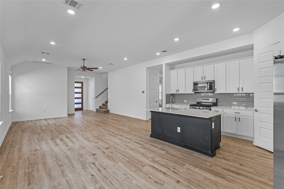 1925 Ruger Pass Leander, TX 78641 - Photo 6 of 26 a large kitchen with kitchen island a sink stainless steel appliances and cabinets