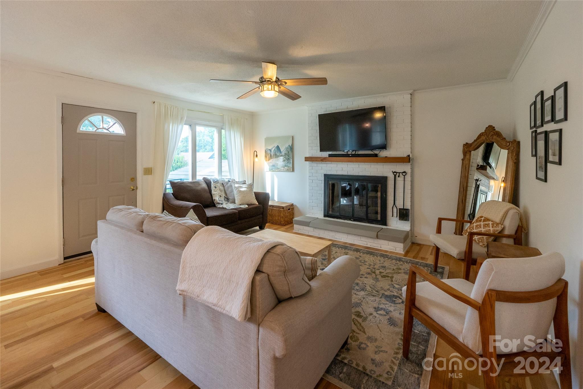 21625 Rio Oro Drive Cornelius, NC 28031 - Photo 11 of 31 a living room with furniture a fireplace and a flat screen tv