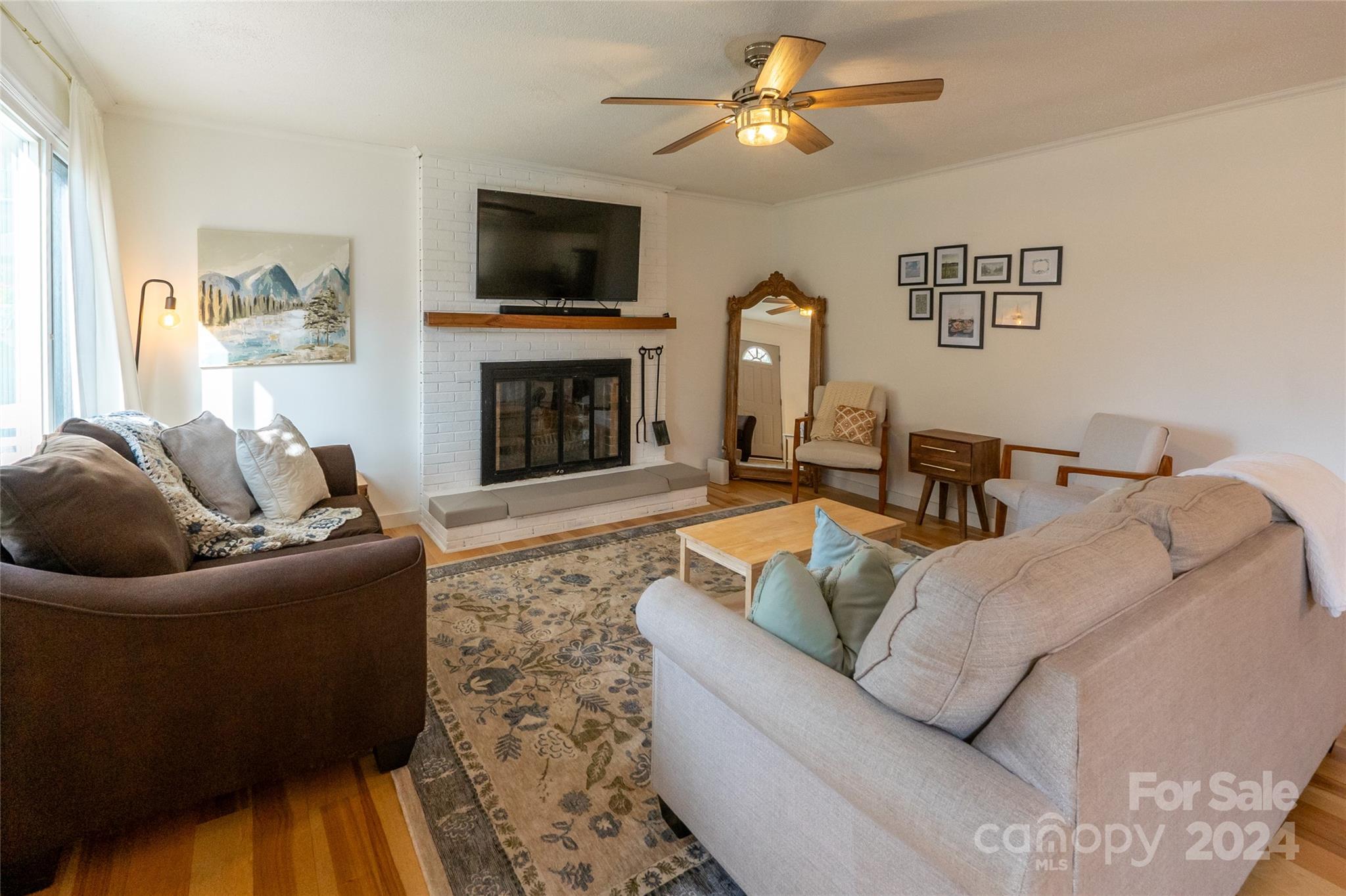21625 Rio Oro Drive Cornelius, NC 28031 - Photo 12 of 31 a living room with furniture a fireplace and a flat screen tv