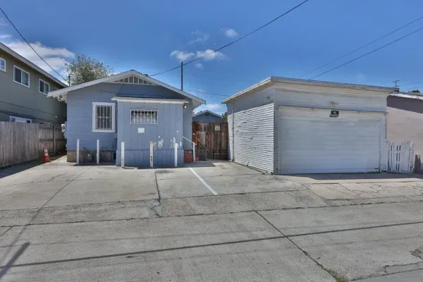 a view of a house with a yard and garage